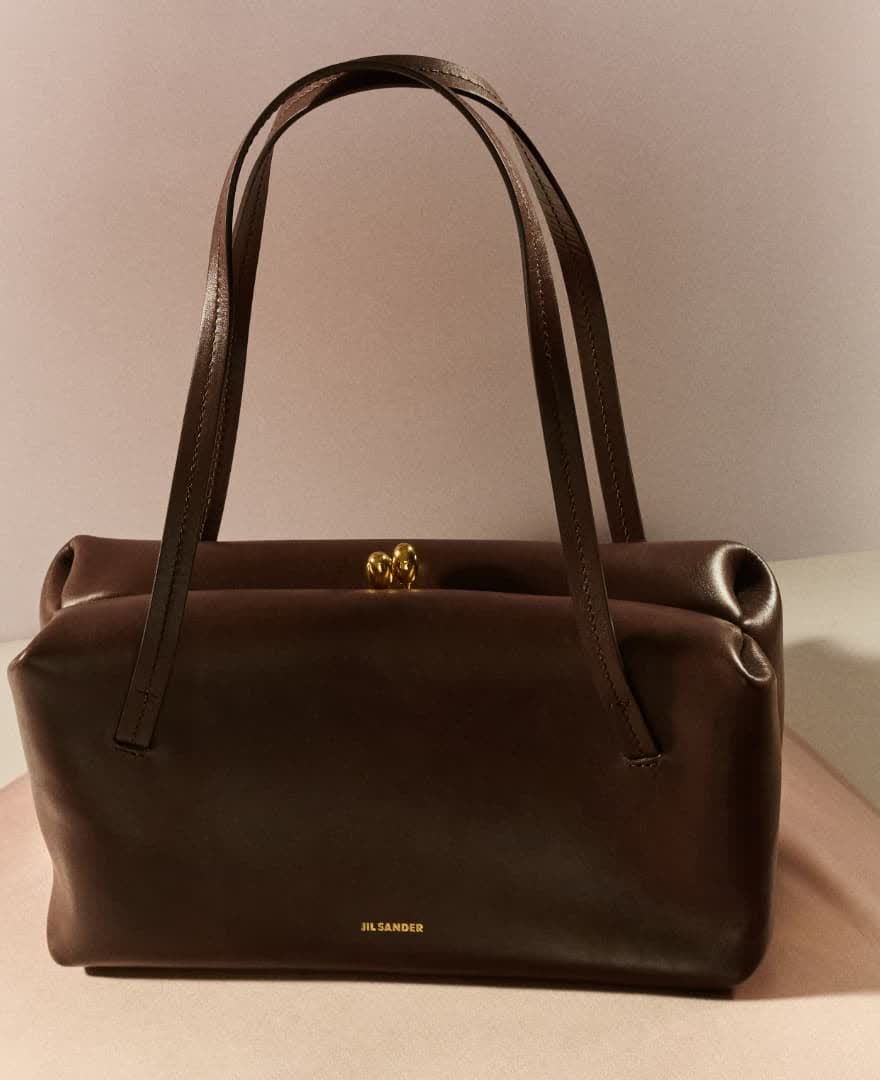 Brown leather Jil Sander handbag with shoulder straps and gold clasp